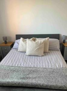 a bedroom with a bed with pillows on it at Whole House Modern Detached 2 Bedroom Coach House in Spalding in Lincolnshire