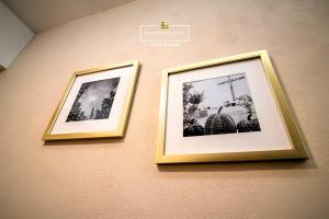 dos fotografías enmarcadas colgando de una pared en A30 Full Suite ‖ Mini Dept at Plaza Acequia, en Cuautitlán Izcalli