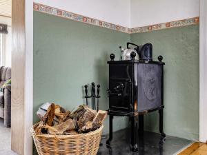 a small stove in a room with a basket of bread at 5 person holiday home in L s in Læsø