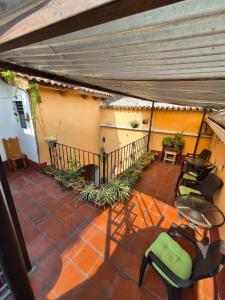 a patio with a table and chairs and a balcony at Hotel Casa Sofia in Antigua Guatemala