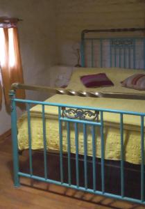 1 cama con barra azul en una habitación en La bodeguita-casa rural en Chilecito