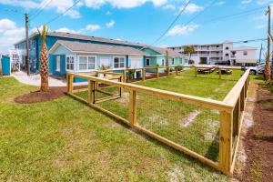 a wooden fence in front of a house at Seabirds Motel At Kure Beach in Kure Beach