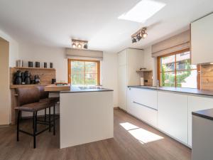 a kitchen with white cabinets and a counter at Chalet Sonnenalp in Hopfgarten im Brixental