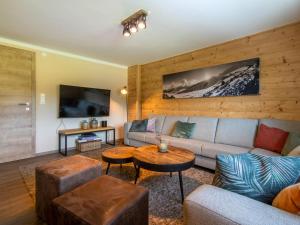 a living room with a couch and a table at Chalet Sonnenalp in Hopfgarten im Brixental