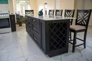 a kitchen with an island with a wine cellar at Kai Dou in Roseau
