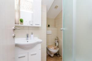 a bathroom with a sink and a toilet at Apartments with parking space Banici, Dubrovnik - 23176 in Slano +17 photos