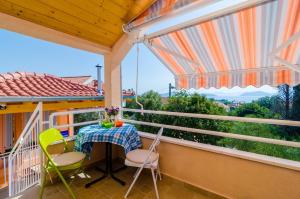 a balcony with a table and chairs and a view at Apartments with parking space Banici, Dubrovnik - 23176 in Slano
