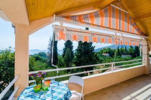 a balcony with a table and a view at Apartments with parking space Banici, Dubrovnik - 23176 in Slano