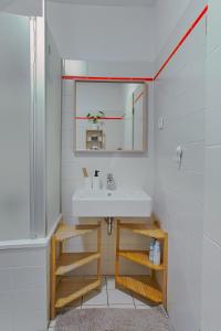 a bathroom with a sink and a mirror at No2 by 21 Apartments in Kaarst