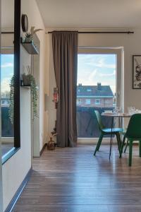 a room with a table and chairs and a large window at No2 by 21 Apartments in Kaarst