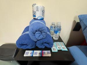 a blue towel on a table next to water bottles at Rooms Zocalo in Mexico City