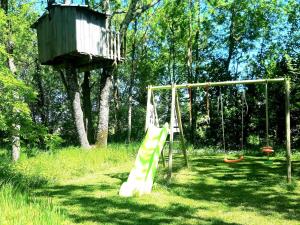 a playground with a slide and a tree house at G te near Saint Emilion in Saint-Martin-de-Gurçon