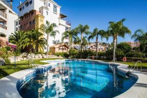 a large swimming pool in front of a building at Penthouse Paradise in Almuñécar