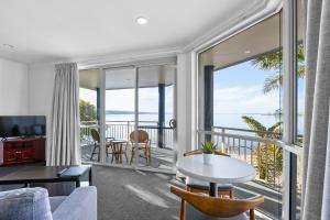 a living room with a view of the ocean at Hilton Motel in Port Lincoln