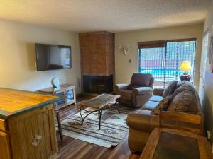 a living room with a couch and a fireplace at Lifts West G8 in Red River