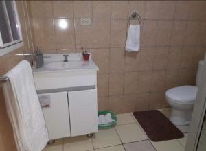 a bathroom with a white sink and a toilet at Abril hospedaje in Juayúa +16 photos