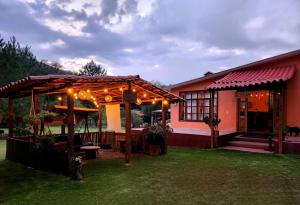 a house with a pergola with lights on it at Rancho San Miguel in Villa del Carbón