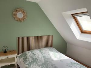 a bedroom with a bed and a mirror on the wall at Duplex 3 Pièces Proche Plage à Cabourg, 6 Pers., Parking Privé - FR-1-487-280 in Varaville