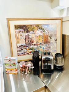 a kitchen counter with a painting of a city at Modern Cozy Home W Free Parking- Close to Downtown & Beach in Victoria