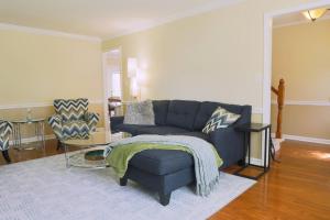 a living room with a blue couch and a table at The Cardinal Cape in High Point