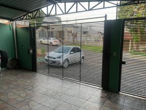 a garage door with a car parked behind it at CASA EM FOZ DO IGUAÇU DESTINO DO MUNDO in Foz do Iguaçu