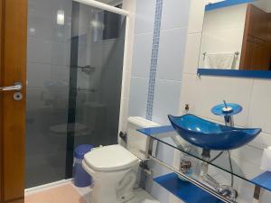 a bathroom with a blue sink and a toilet at CASA EM FOZ DO IGUAÇU DESTINO DO MUNDO in Foz do Iguaçu +12 photos