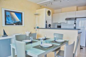 a dining room with a blue table and chairs at Lovely 51 m with harbour view in Saint-Cyprien