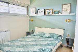 a bedroom with a bed with a blue wall at Lovely 51 m with harbour view in Saint-Cyprien
