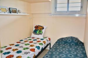 a small bedroom with a bed and a window at Lovely 51 m with harbour view in Saint-Cyprien +5 photos