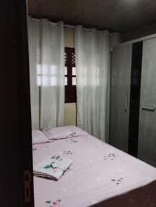 a bedroom with a bed with flowers on it at Na Jatiuca in Maceió