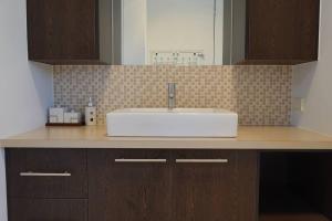 a bathroom counter with a sink and a mirror at Waterfront Primrose Retreat in Primrose Sands +33 photos