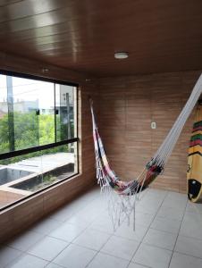 a hammock hanging from a wall in a room at Na Jatiuca in Maceió