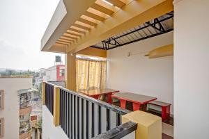 a balcony with a table and benches on it at Collection O The Transit in Dispur