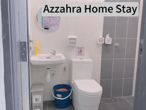 a small bathroom with a toilet and a sink at Az-zahra Home Stay Kulim Hi-Tech in Kulim