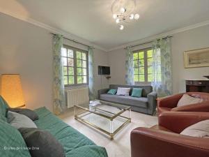 a living room with two couches and a coffee table at Maison confortable dans le Perche avec jardin et animaux admis - FR-1-497-205 in Longny-au-Perche