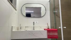 a bathroom with a sink and a mirror at CASA HOTEL PIRACICABA in Piracicaba