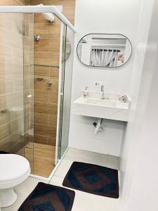 a small bathroom with a sink and a shower at CASA HOTEL PIRACICABA in Piracicaba