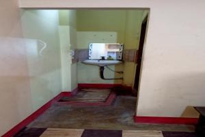 a small bathroom with a sink in a room at OYO Prabha Guest House in Robertsganj