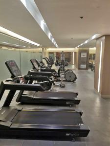 a row of treadmills in a gym with a row at Shore 3 mall of Asia condotel in Manila