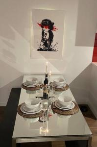 a table with plates and glasses and a candle at Fitzroy Zen in Melbourne