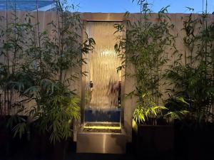 a person standing in front of a door with plants at Fitzroy Zen in Melbourne