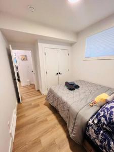 a bedroom with a bed and a wooden floor at B19 Modern Stylish 2bed Basement Suite in Edmonton