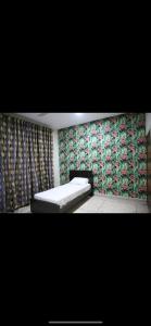 a bedroom with a bed and a wall with floral wallpaper at 6 bedrooms Villa in DHA in Lahore