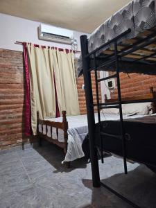 a bedroom with two bunk beds and a window at El gumer in San Fernando del Valle de Catamarca