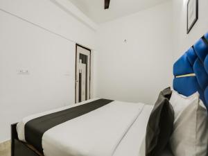 uma cama branca num quarto com uma janela em OYO Happy Home Residency em Nova Deli