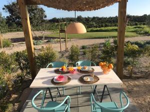 a table with plates of food on it on a patio at Tavira-Quinta da Janela Azul in Tavira