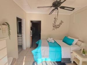 a bedroom with a bed and a ceiling fan at Sea La Vie in Richards Bay