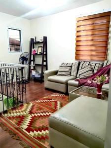 a living room with a couch and a rug at Casa De Mira in Angeles