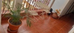 a balcony with plants and a chair on a floor at Hotel Maya America in Panajachel
