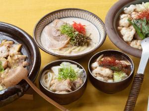 a group of bowls of food on a table at Vessel Hotel Fukuoka Kaizuka in Fukuoka